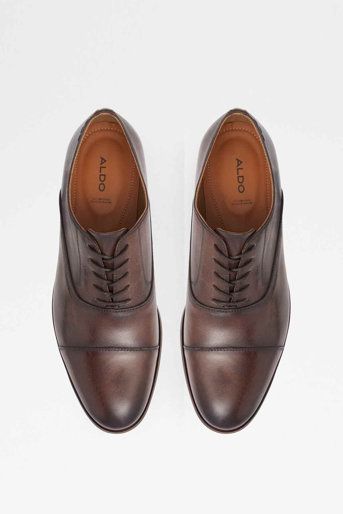 Pair of brown leather lace-up oxfords, laces and padded collar visible