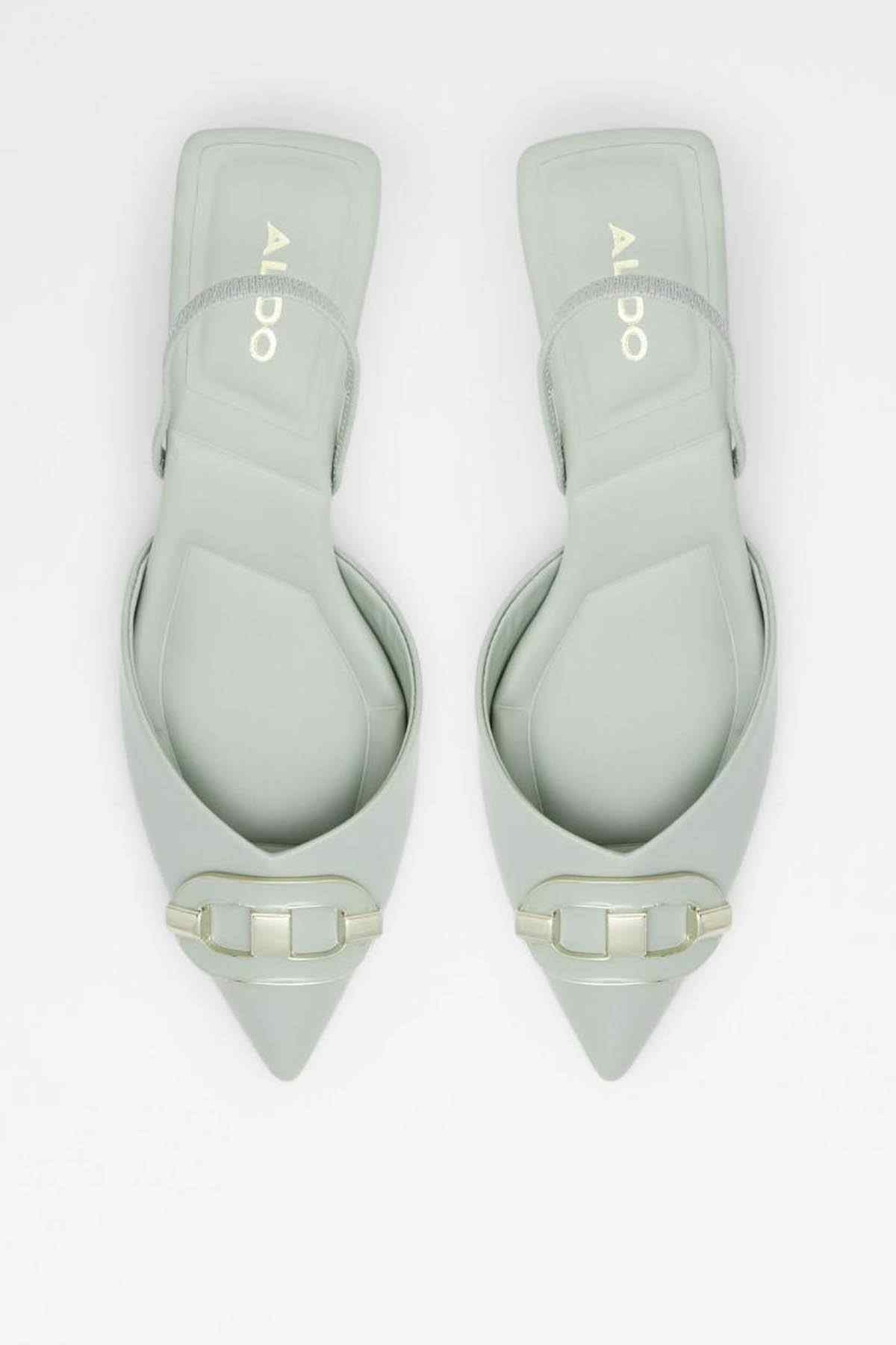 Pair of sage green pointed-toe slingback heels with gold buckle straps