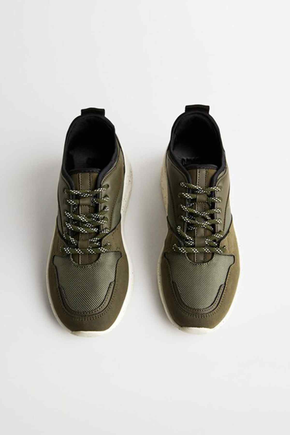 Khaki lace-up sneakers pair, textured uppers and black collars, chunky sole