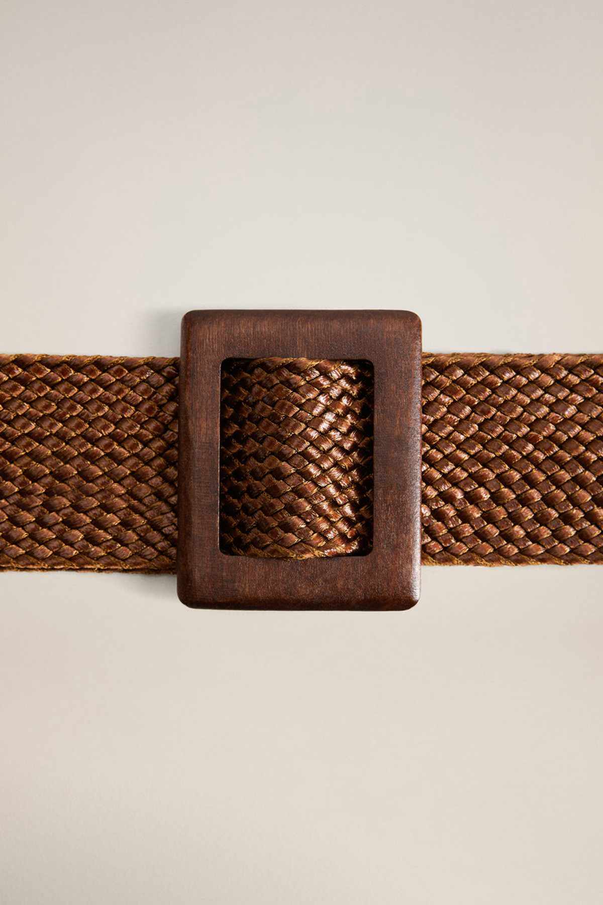 Medium brown woven belt with square rectangular buckle close-up