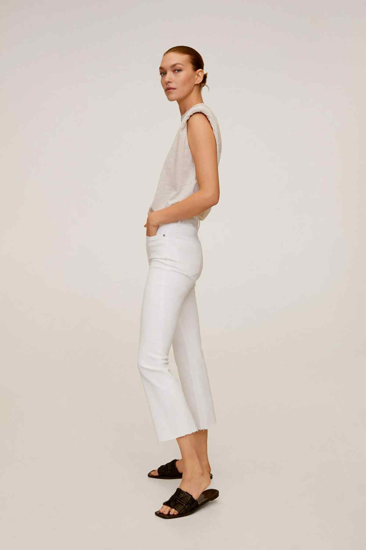White cropped jeans with cuffed hem and straight fit, side view