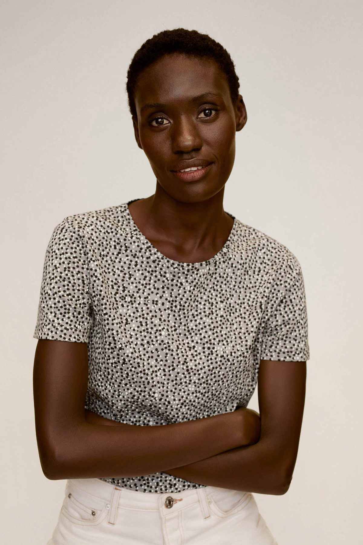 Off-white speckled short-sleeve knit top with round neckline