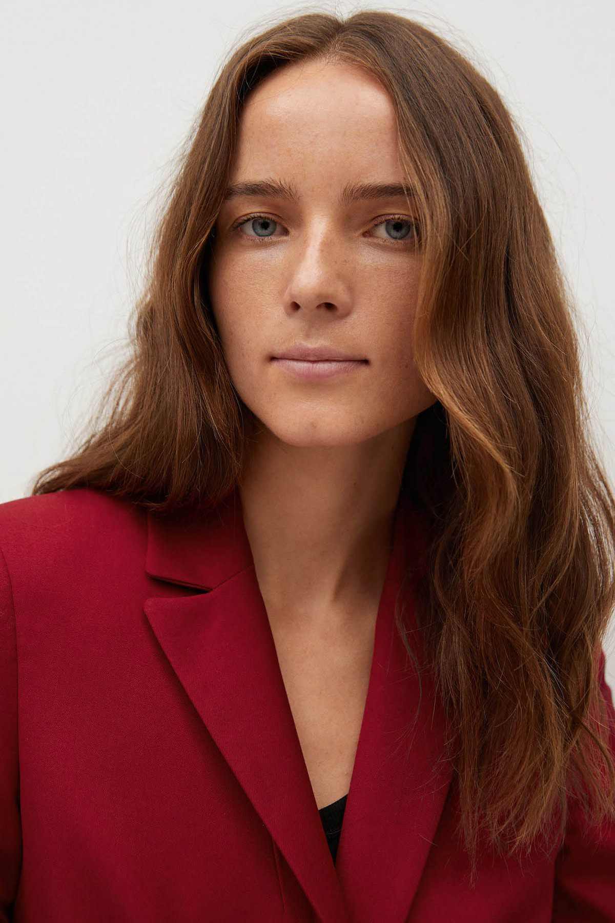 Red women's blazer close-up with notch lapels and structured collar