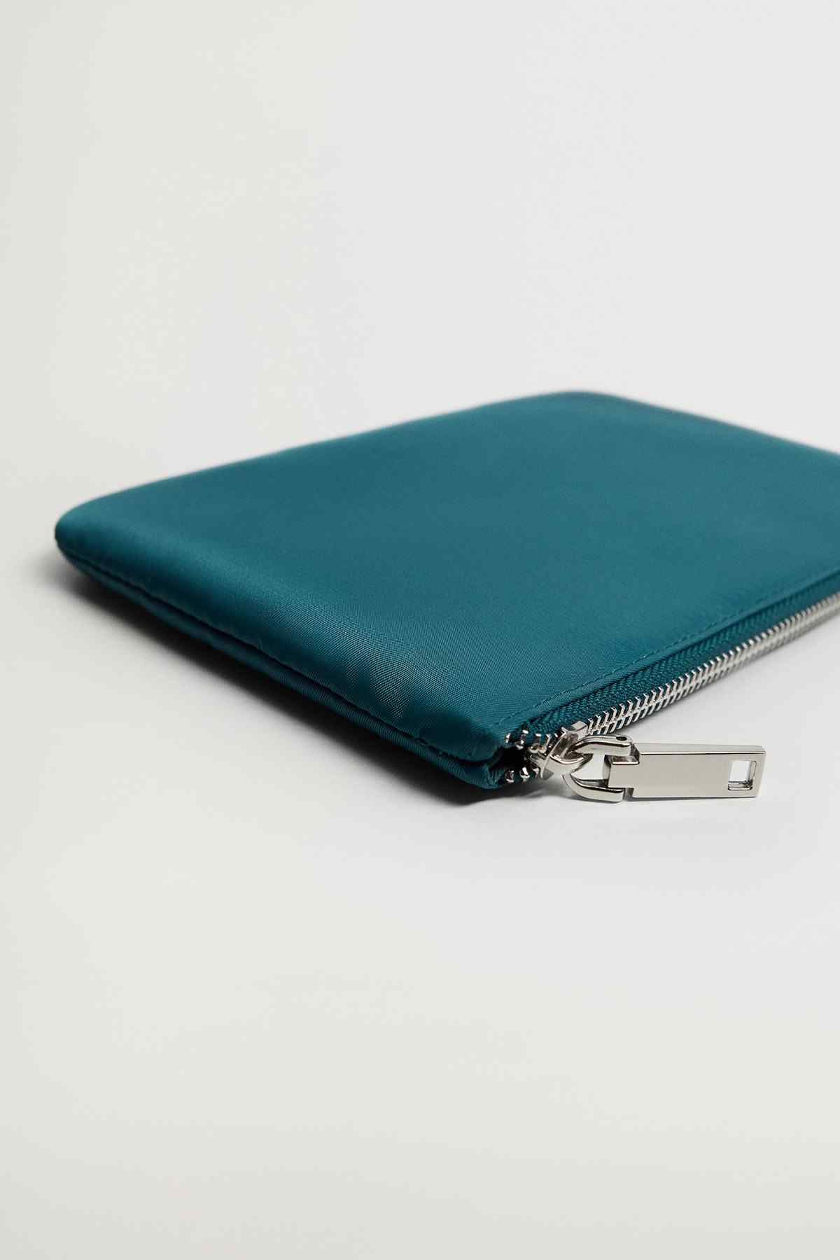 Petrol blue zip pouch corner with metal zipper pull and stitching
