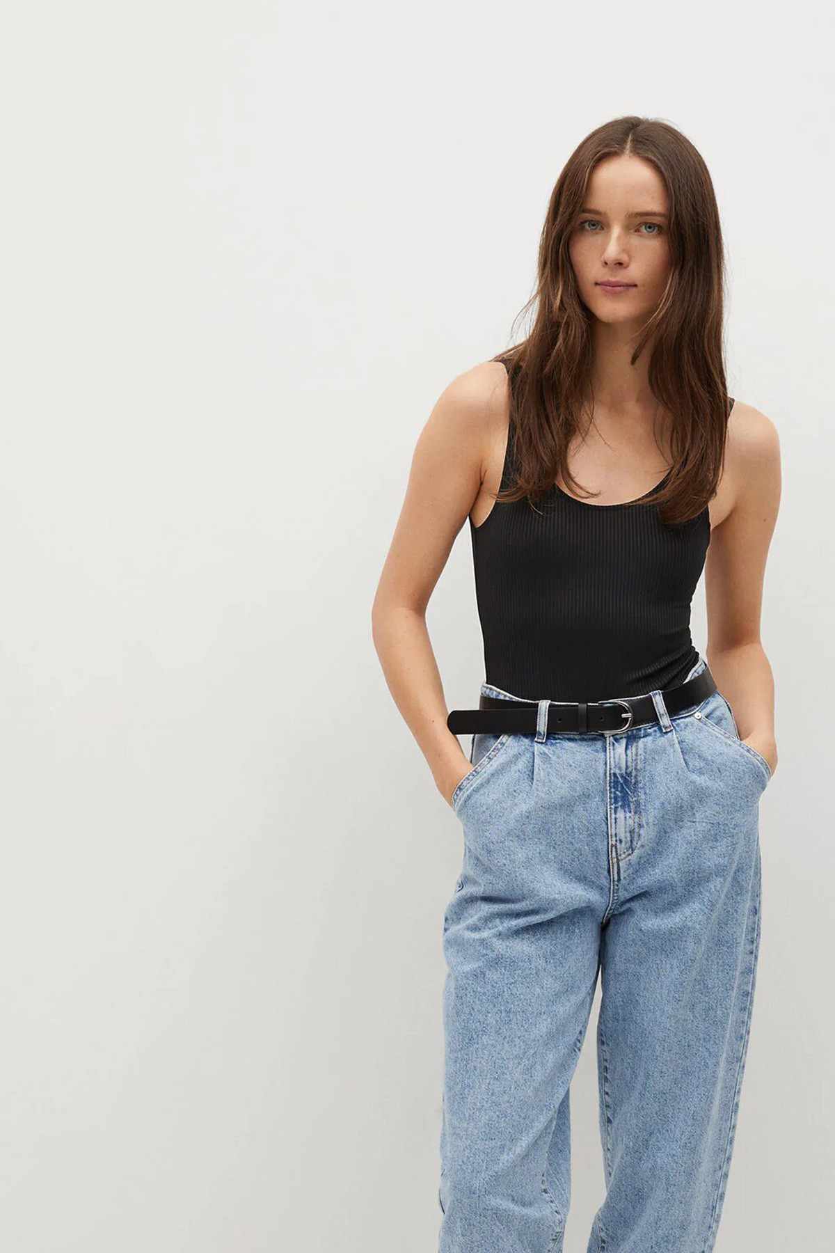 Black sleeveless scoop-neck tank top, straight hem, worn with jeans