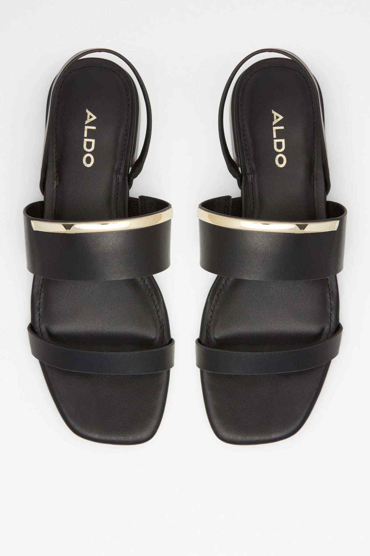 Black ALDO slide sandals, top view of footbed with gold-trimmed strap edges