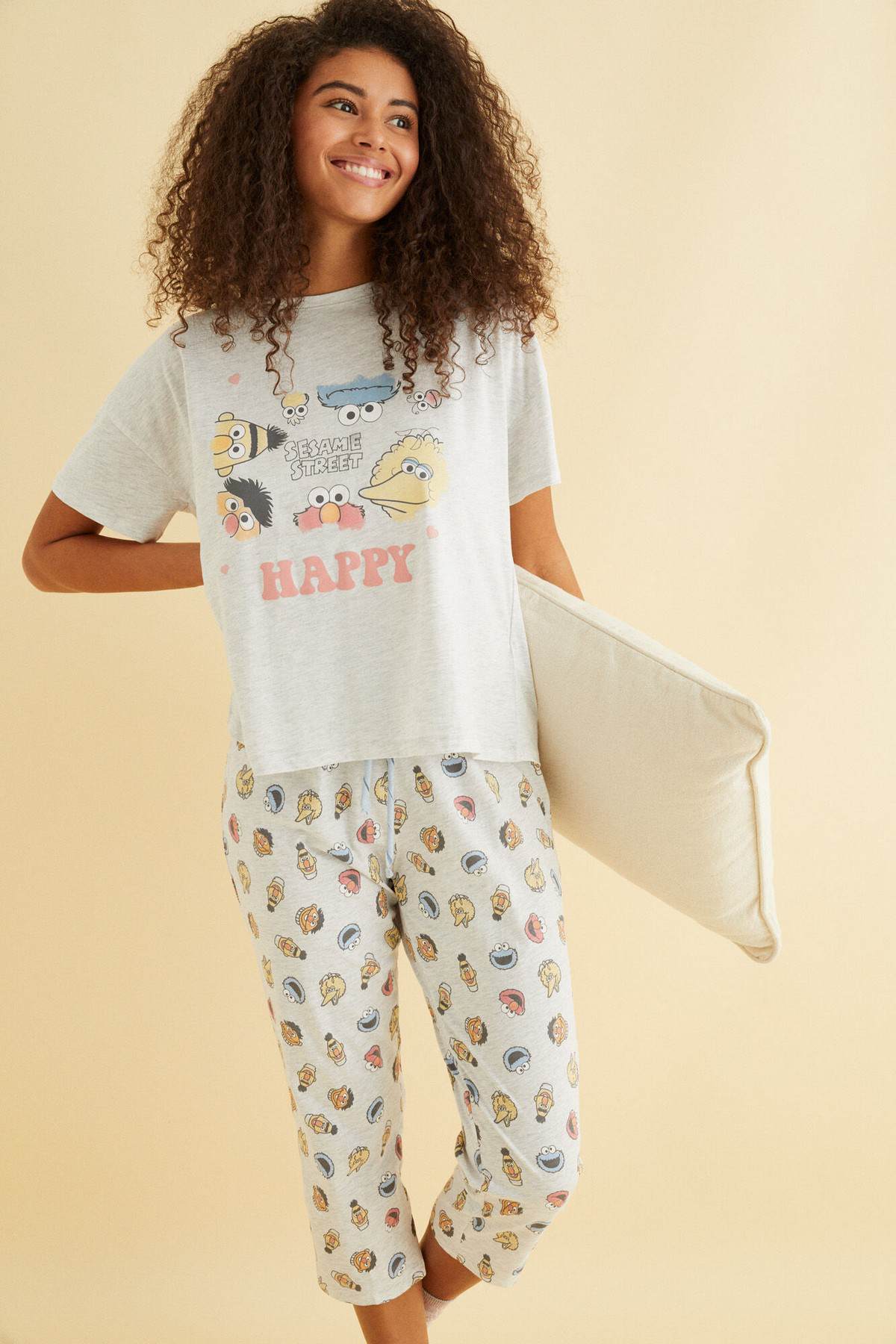 Women'secret printed pajama set with capri pants, holding a light blanket