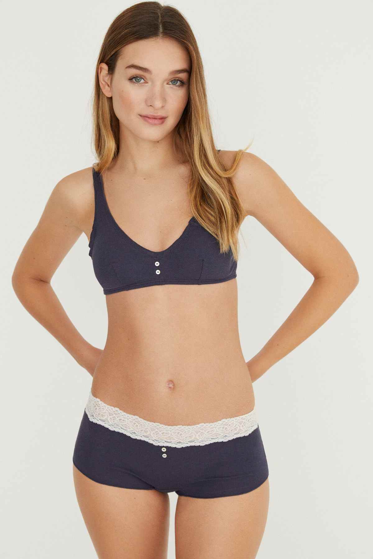 Dark blue lace-trim bralette and boxer shorts set on model