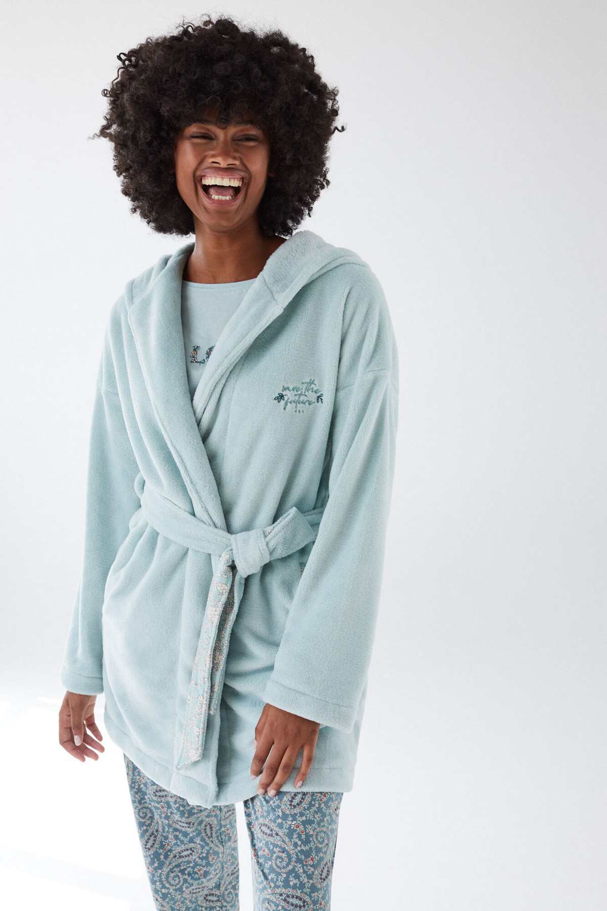 Light blue hooded bathrobe with tie belt and chest embroidery, worn with print pants