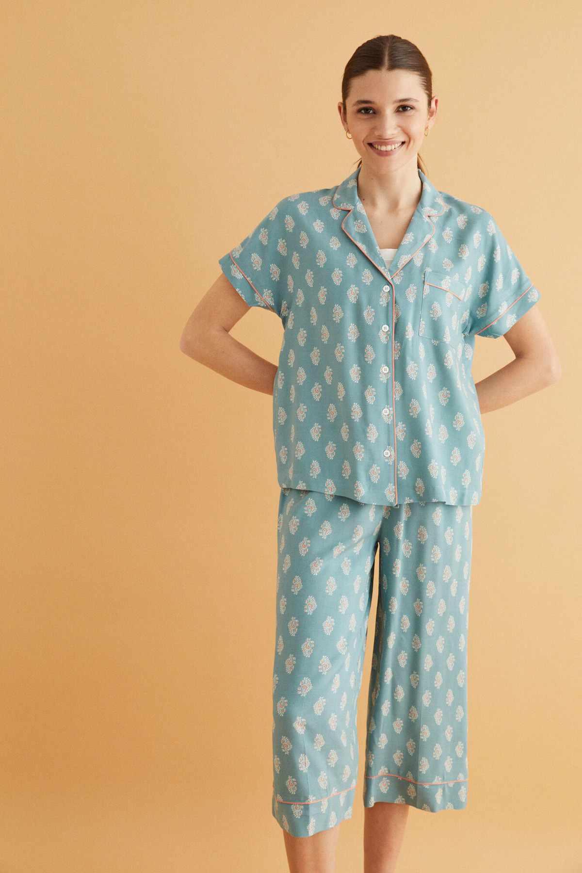 Light blue printed pajama set with short sleeves, button front, and cropped pants
