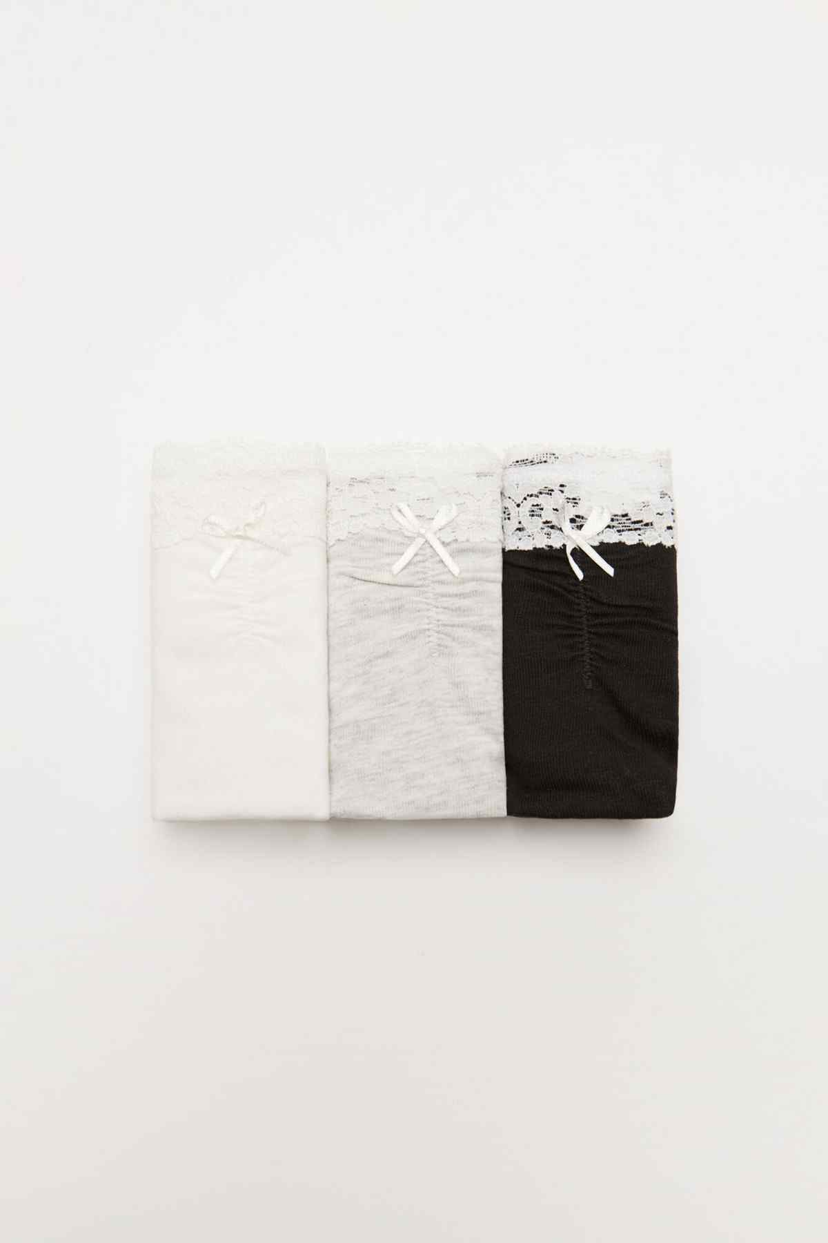 Set of four lace panties in white, beige, gray, and black
