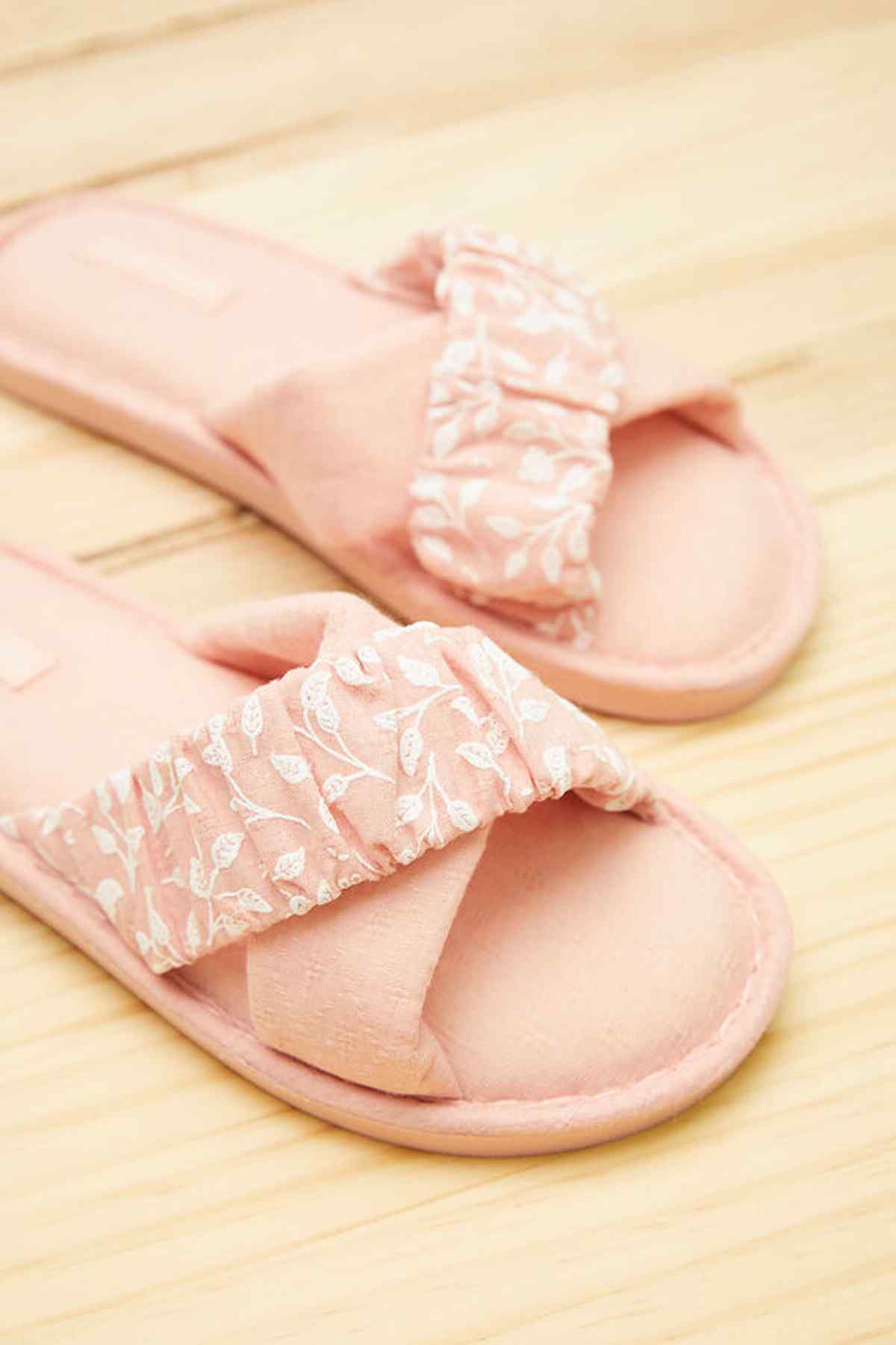 Pink close-up ruffle slide sandals with textured strap and open toe