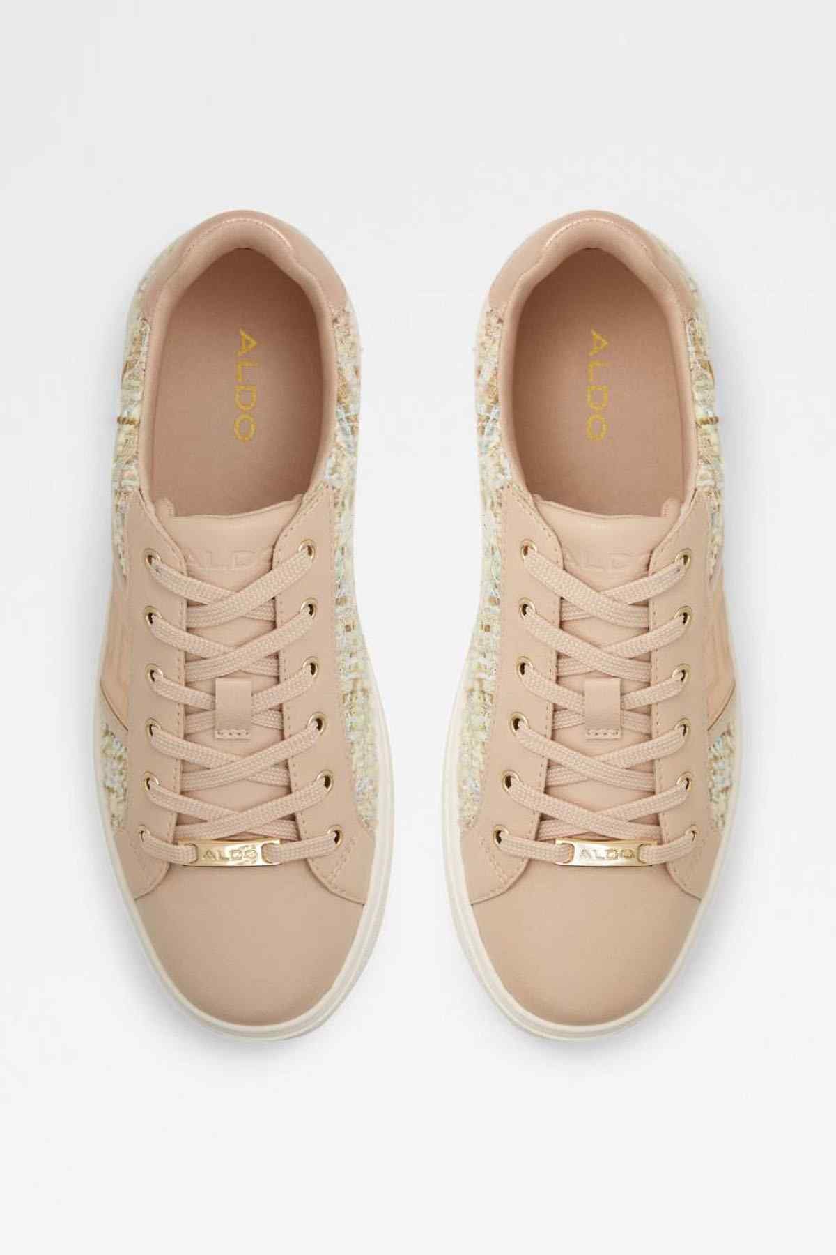 Pair of beige lace-up sneakers with tan interior lining and logo insole detail
