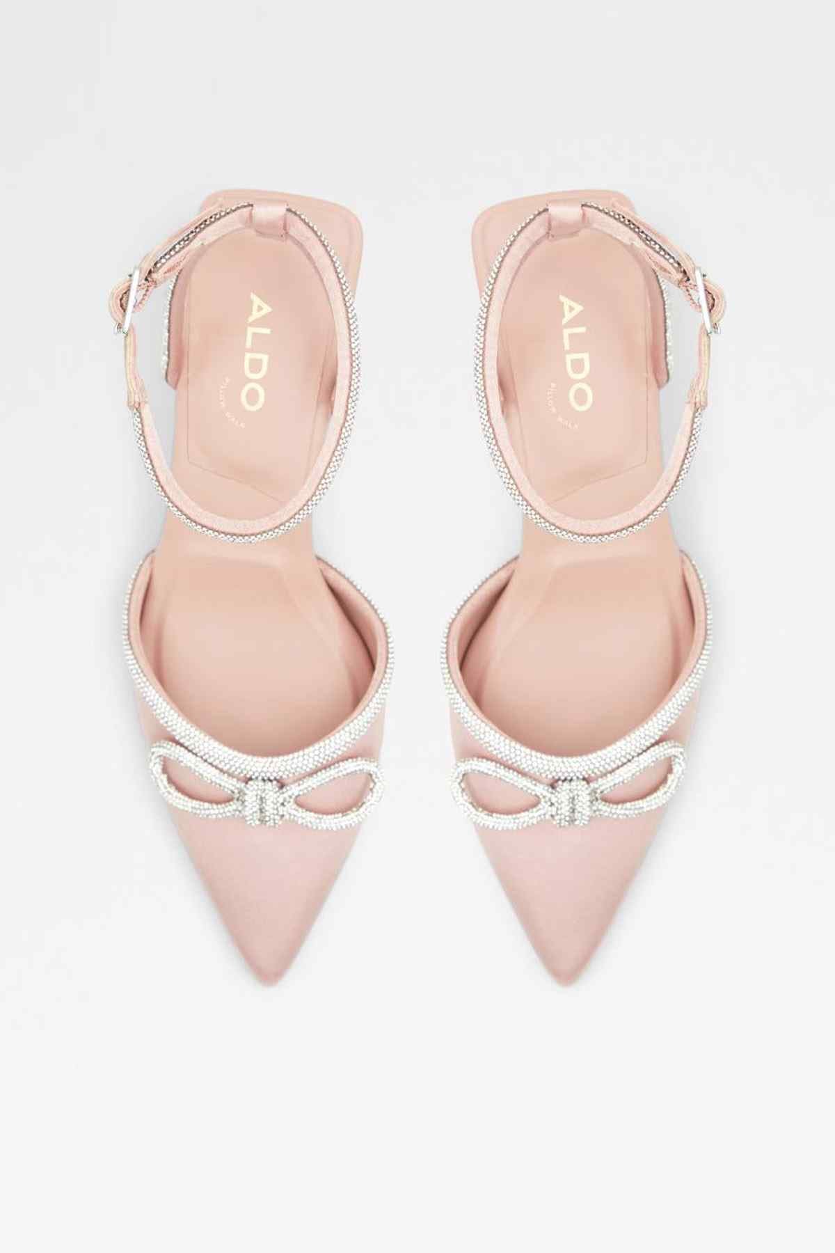 Pair of pink slingback pumps with rhinestone bow detail and ankle straps