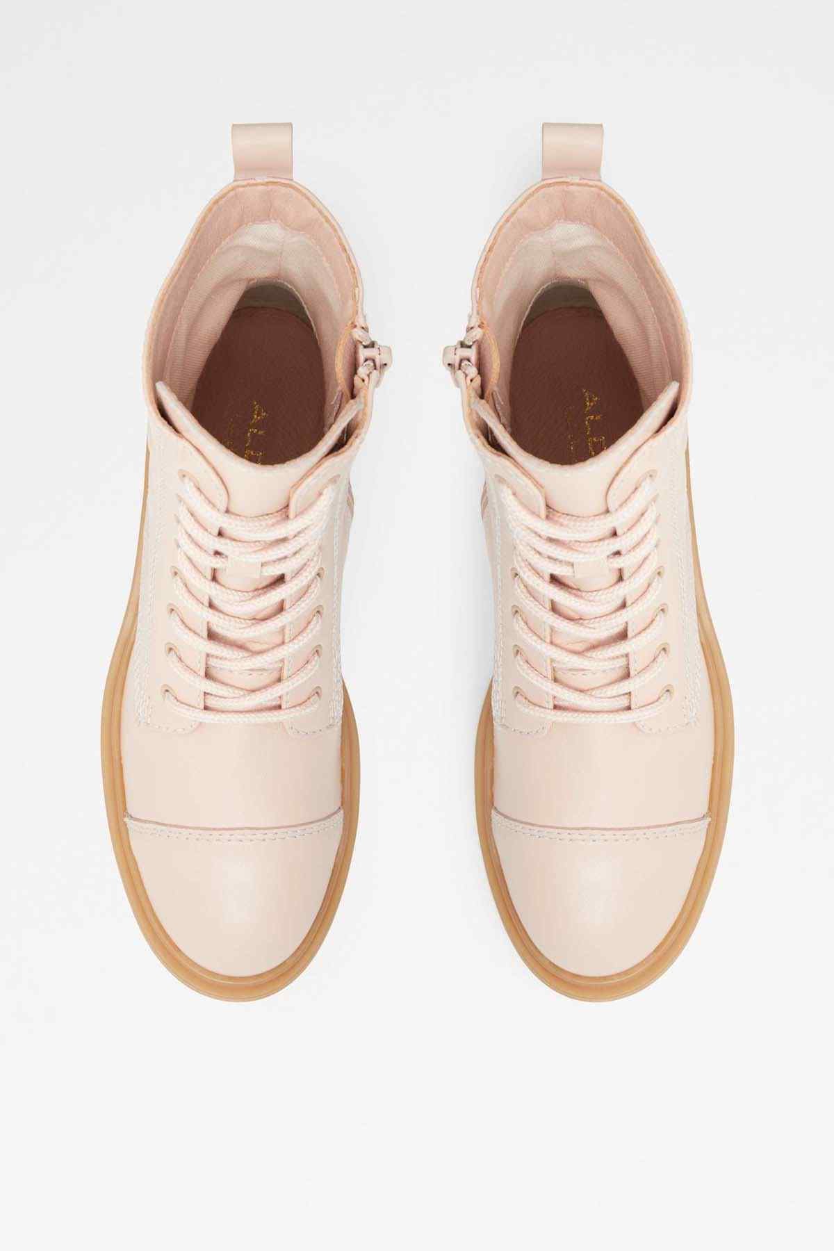 Pair of natural beige lace-up ankle boots with tan interior lining