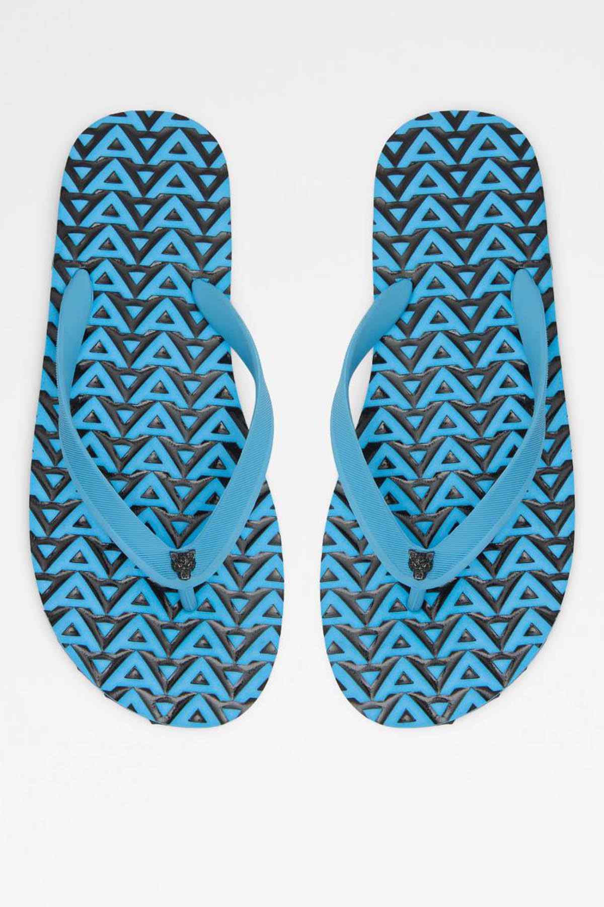 Pair of bright blue flip-flops showing patterned textured footbeds and tread