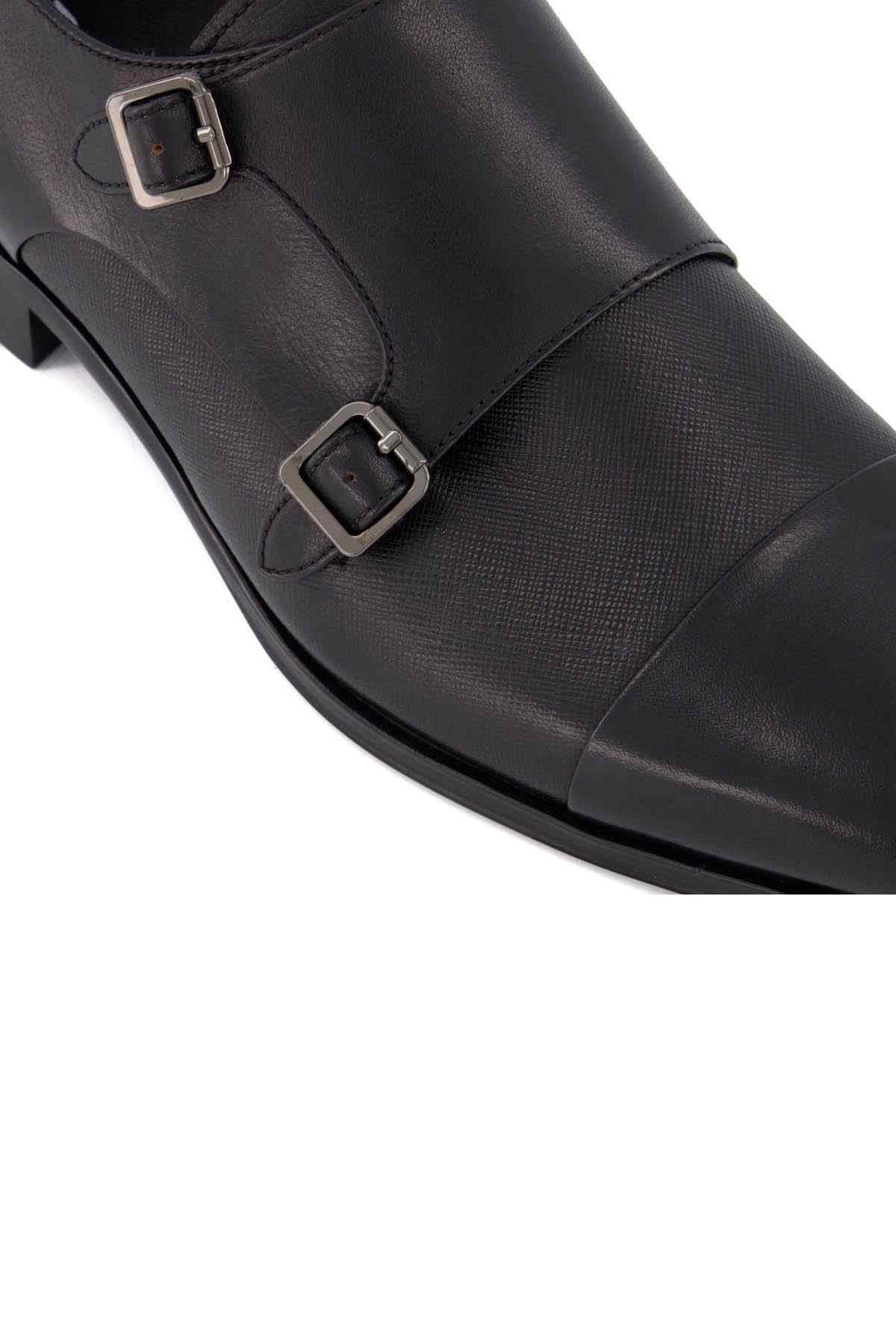 Close-up of black leather monk strap shoes with two metal buckles
