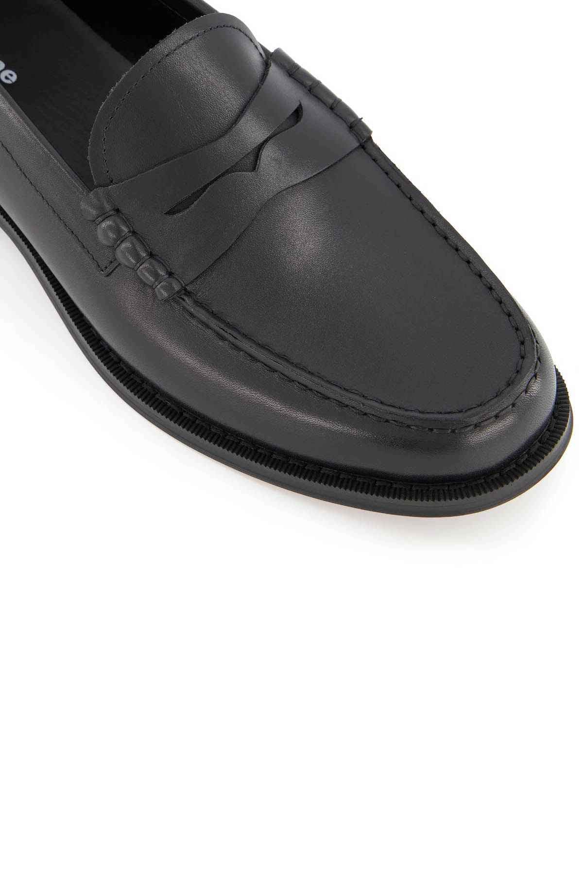 Black leather loafer with loop strap and stitched moc toe, side close-up