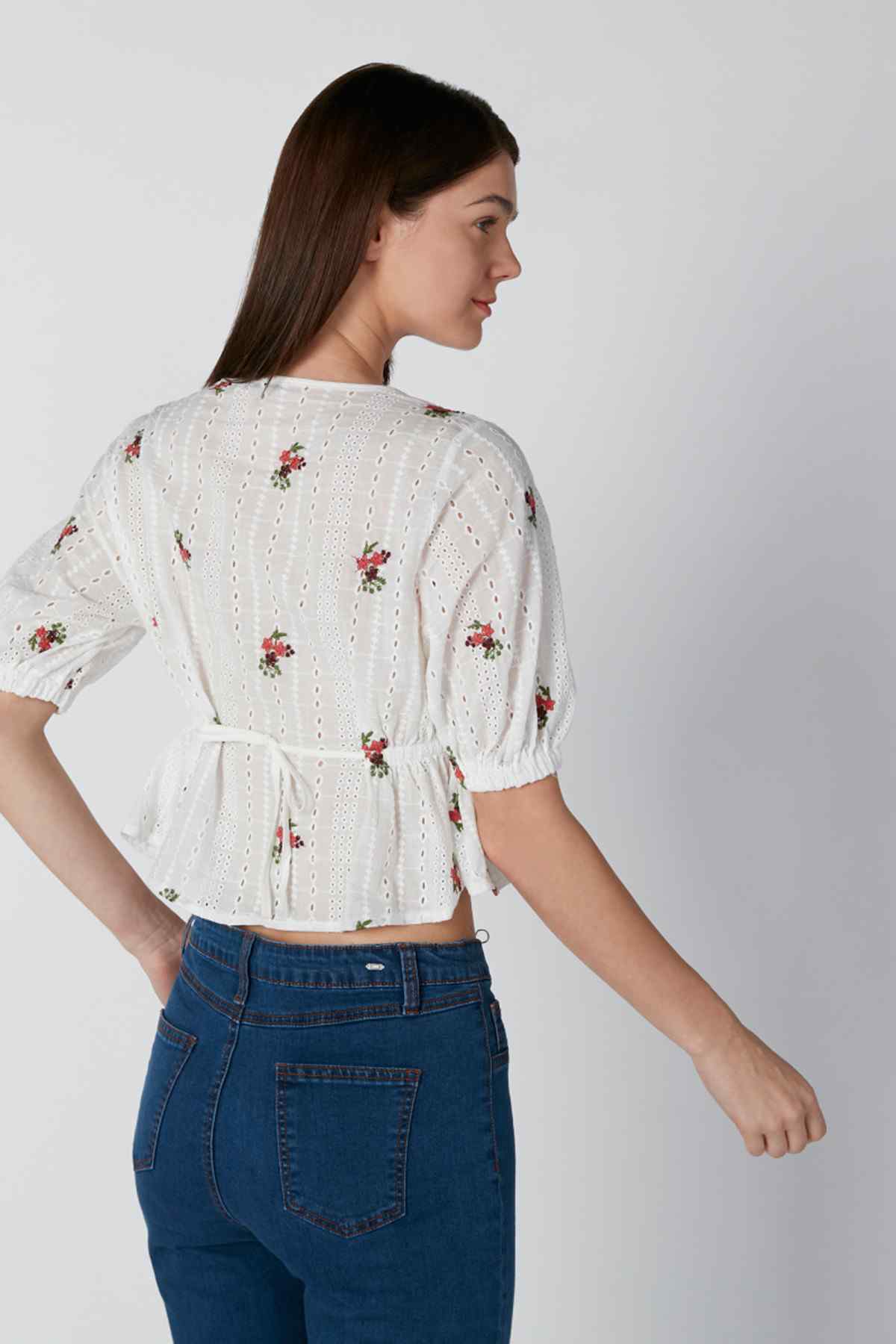 White floral print peasant blouse, back view with puff sleeves and tie waist