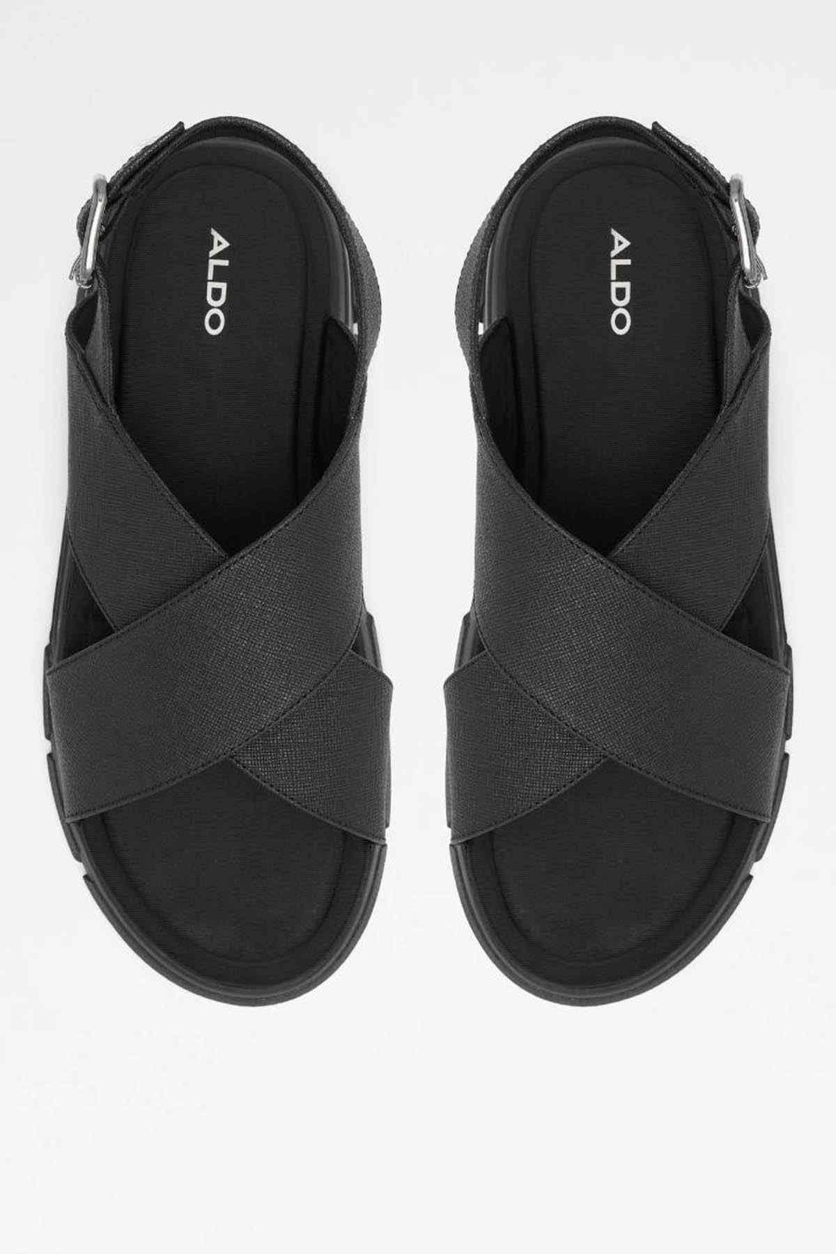 Pair of black sandals with cross straps and adjustable ankle buckle
