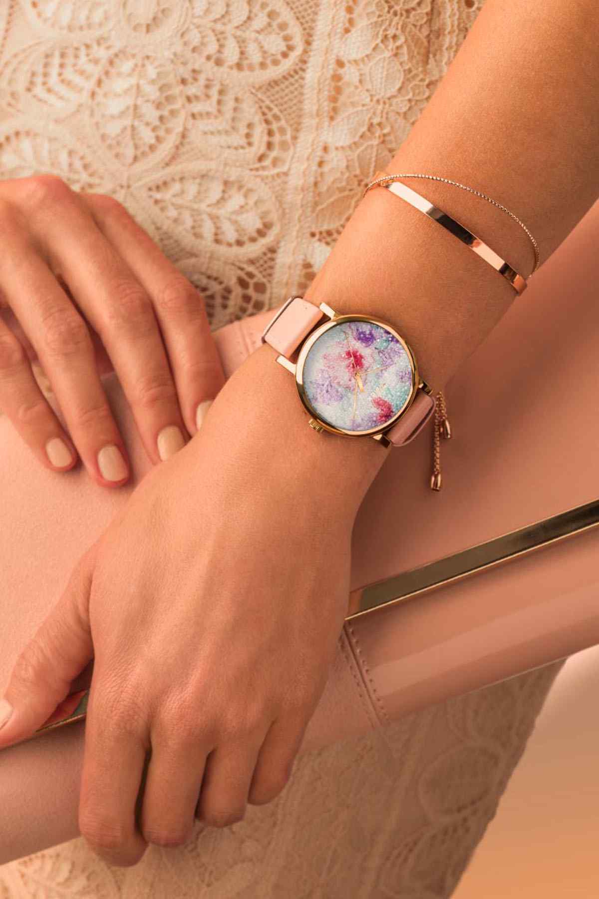 TIMEX watch on wrist with pink leather-look strap, gold-tone case, and speckled dial
