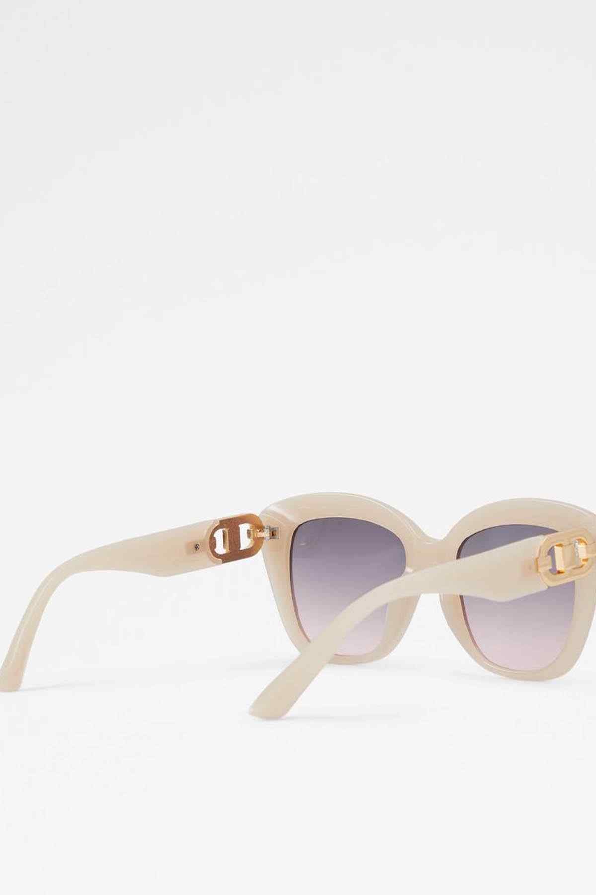ALDO sunglasses angled side view, light beige frame, purple gradient lenses, gold logo