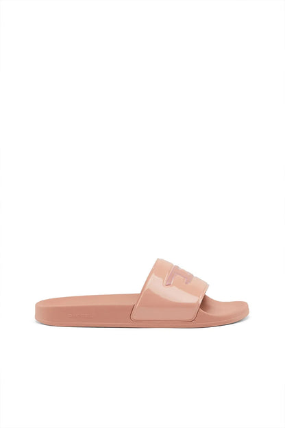 Pink slip-on slide sandals with wide strap and rectangular Diesel logo buckle