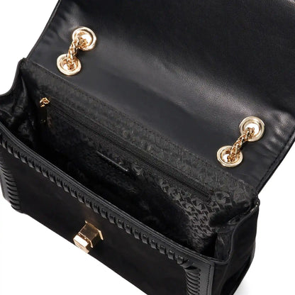 Close-up of black bag flap with embossed lining, gold clasp, and hardware rings.
