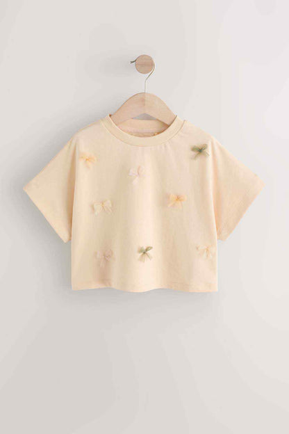Ecru embroidered kids T-shirt, short sleeves on wooden hanger