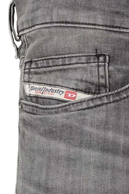 Diesel jeans close-up: back pocket label with red logo patch