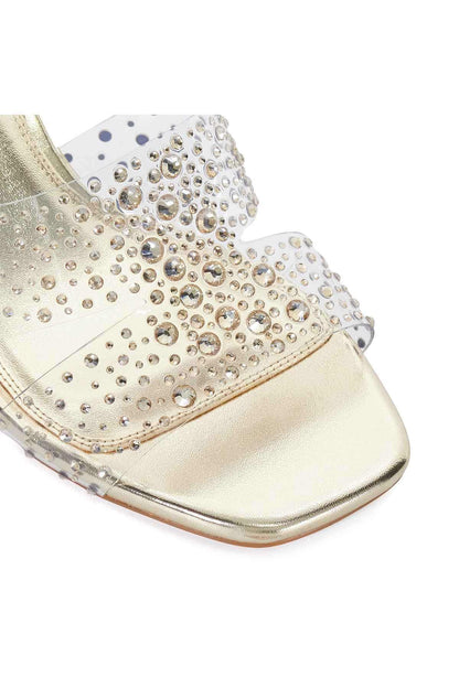 Gold heeled mule close-up with rhinestone pattern and gold trim