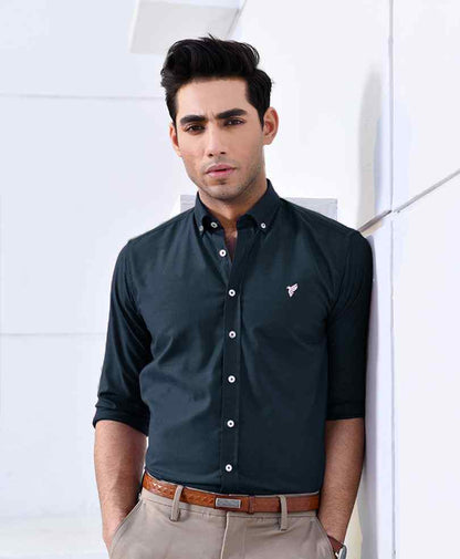 Dark green fitted button-up shirt with long sleeves and chest logo