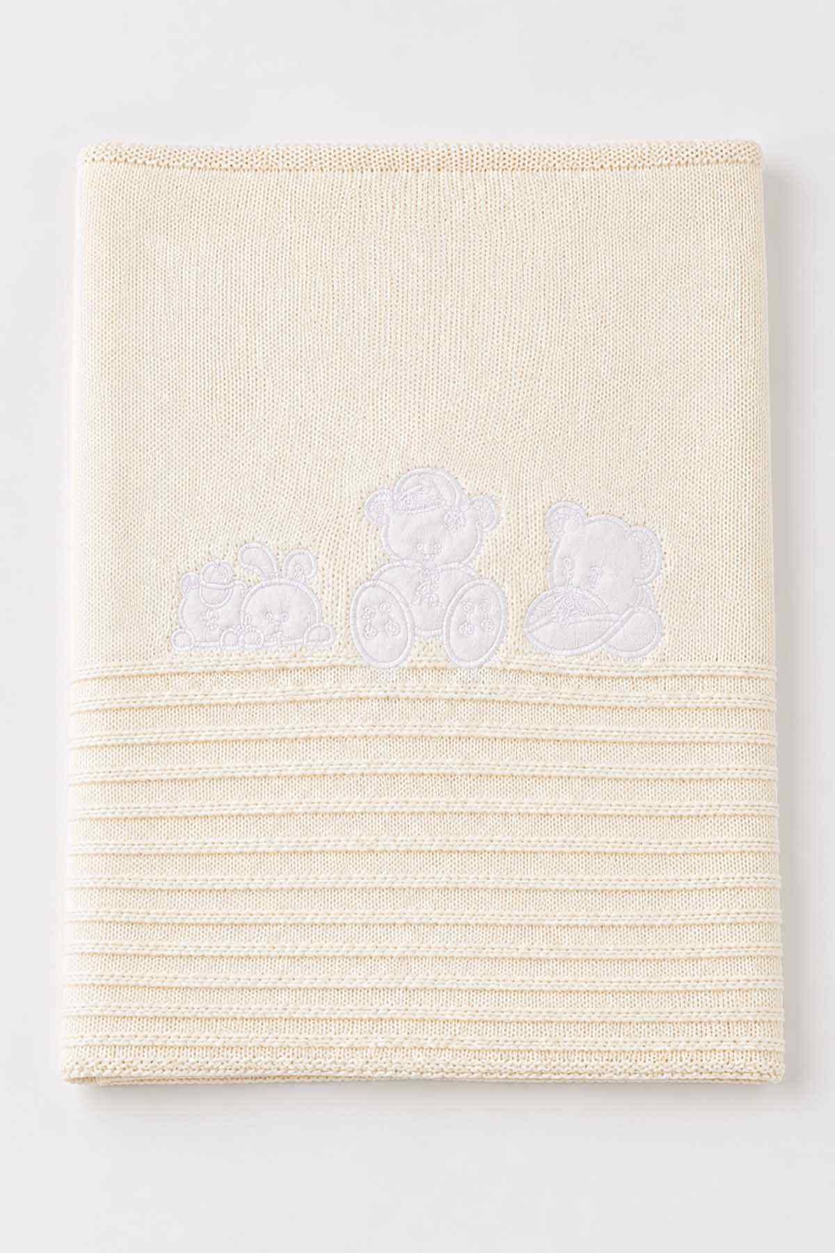 Cream baby shawl blanket with teddy bear applique and striped knit texture