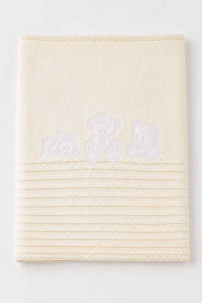 Cream baby shawl blanket with teddy bear applique and striped knit texture