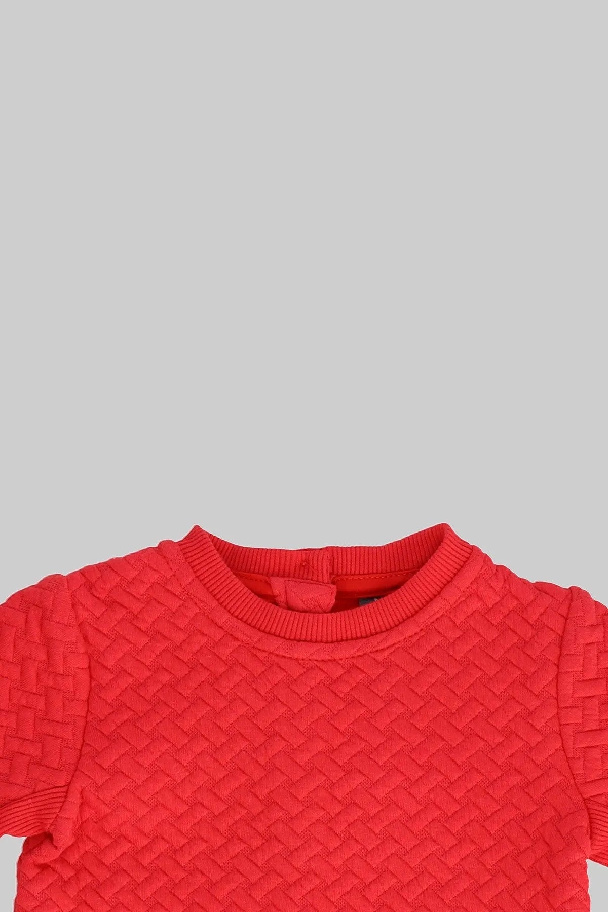 Red textured knit baby sweatshirt, crew neckline ribbing close-up