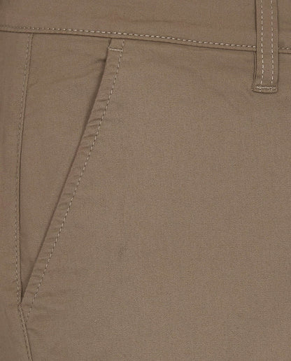 Beige shorts side seam close-up with stitched panel detail