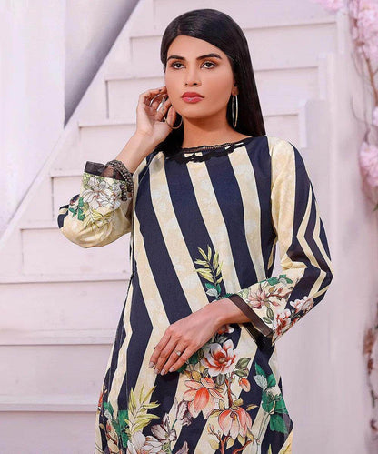 Striped long-sleeve tunic with floral panel, round neckline, paired with black pants