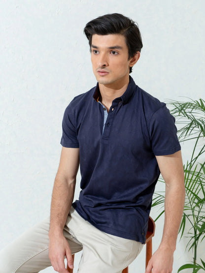 Navy polo shirt with short sleeves, buttoned placket, and straight hem