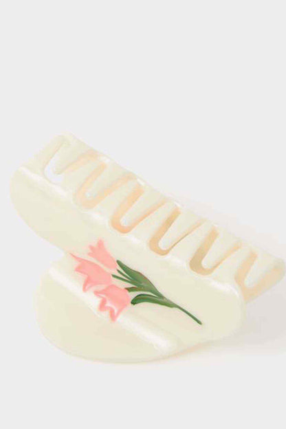 Cream slide sandals with pink floral applique and raised striped lettering