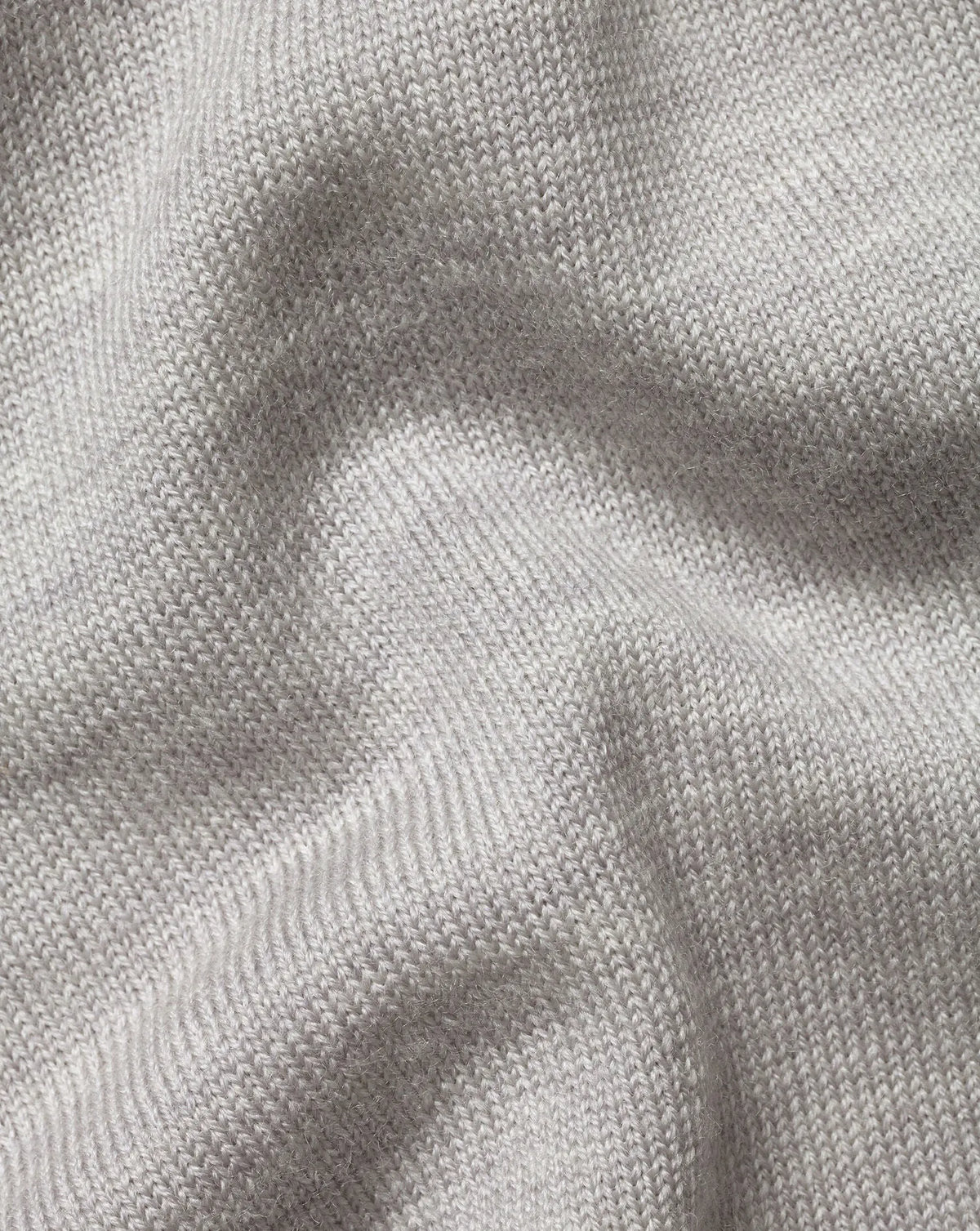Grey knit sweater fabric texture with fine ribbed stitch detail