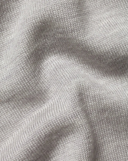 Grey knit sweater fabric texture with fine ribbed stitch detail
