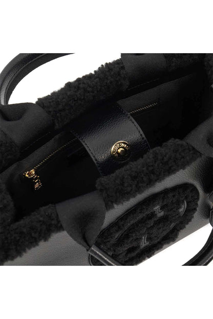 Black handbag interior with fuzzy lining, zipper closure, and gold-tone hardware.