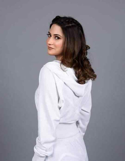 White zip hoodie with hood and joggers; side view with long sleeves and drawstring.