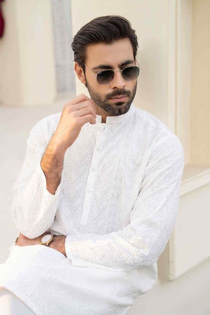 White long kurta with stand collar and detailed embroidery front panel, arms crossed pose