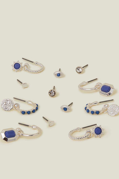 Assorted silver-tone earrings with blue oval and octagon stones, some stud and drop.