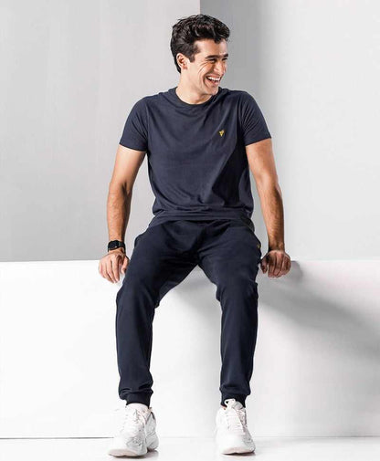 Fitted dark navy jogger pants with tapered legs and elastic waistband