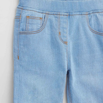 Light blue denim baby pants close-up of side seam and curved front pocket