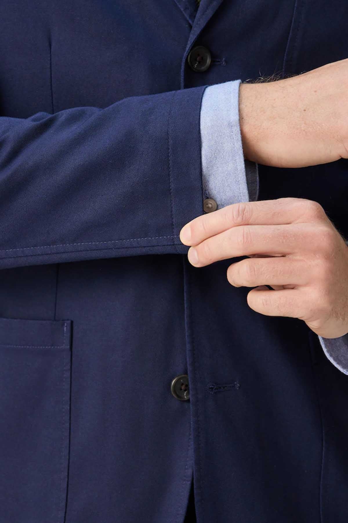 Navy suit jacket sleeve cuff with button fastening