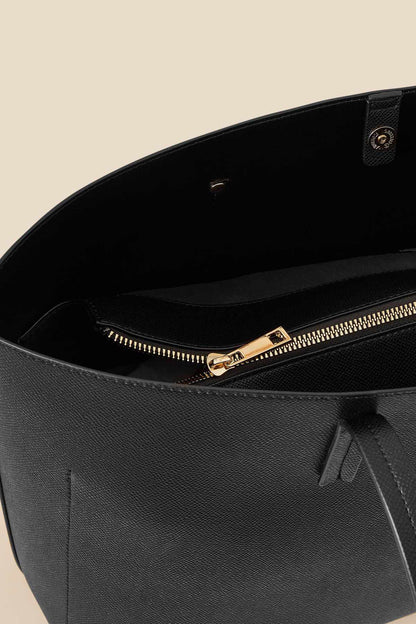 Black tote bag interior with zip top and gold-tone zipper pull.