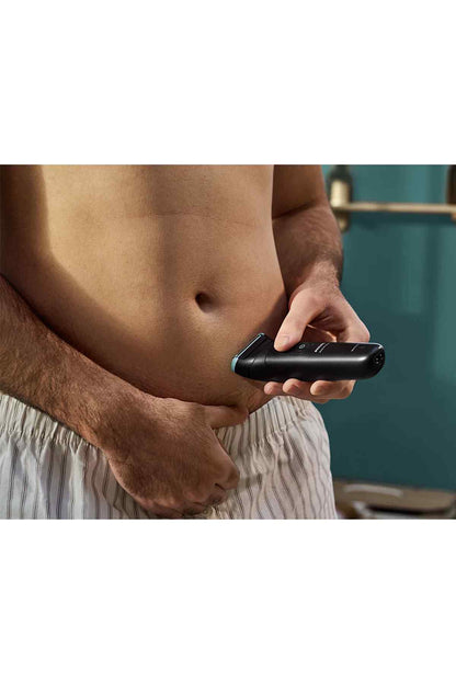 Black Philips grooming trimmer with blue-tipped guard for detailed body trimming